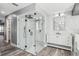 Contemporary bathroom with a glass shower, marble tile, and a white vanity at 1010 Emerald Creek Dr, Valrico, FL 33596