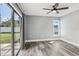 Bedroom with sliding glass doors and ceiling fan at 1010 Emerald Creek Dr, Valrico, FL 33596