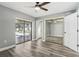 Bedroom with wood-look floors, sliding glass doors, and pool view at 1010 Emerald Creek Dr, Valrico, FL 33596