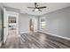 Bedroom with wood-look floors, access to bathroom and pool view at 1010 Emerald Creek Dr, Valrico, FL 33596