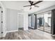 Bright bedroom with wood-look floors and sliding glass doors leading to a patio at 1010 Emerald Creek Dr, Valrico, FL 33596