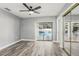 Bedroom with wood-look floors, mirrored closet doors, and pool view at 1010 Emerald Creek Dr, Valrico, FL 33596