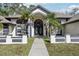 Front entrance with double doors and palm trees at 1010 Emerald Creek Dr, Valrico, FL 33596