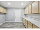 Bright laundry room with ample cabinetry and modern flooring at 1010 Emerald Creek Dr, Valrico, FL 33596