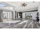 Sunlit living area with hardwood floors and sliding doors to patio at 1010 Emerald Creek Dr, Valrico, FL 33596