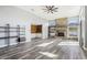 Spacious living room featuring a stone fireplace and wood-look flooring at 1010 Emerald Creek Dr, Valrico, FL 33596