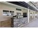 Outdoor kitchen with stone facade and grill at 1010 Emerald Creek Dr, Valrico, FL 33596