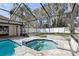 Octagonal spa with stone coping and a screened enclosure at 1010 Emerald Creek Dr, Valrico, FL 33596