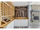 Elegant wine cellar with built-in wooden racks and a rustic-style stone feature wall at 1010 Emerald Creek Dr, Valrico, FL 33596