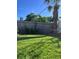 Spacious backyard with grassy lawn and wooden fence at 1019 Mandalay Ave, Clearwater Beach, FL 33767