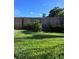 Green grassy backyard with a wooden fence at 1019 Mandalay Ave, Clearwater Beach, FL 33767