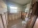 Under renovation bathroom, toilet visible, exposed walls and flooring at 1019 Mandalay Ave, Clearwater Beach, FL 33767