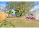 Fenced backyard with mature trees and a grassy area at 11395 83Rd Ave, Seminole, FL 33772