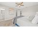 Comfortable bedroom with a blue bed, ceiling fan, and plenty of natural light at 11395 83Rd Ave, Seminole, FL 33772