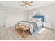 Bright bedroom featuring a blue headboard, ceiling fan, and a cozy rug at 11395 83Rd Ave, Seminole, FL 33772