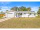 Updated mid-century home with modern landscaping and a new garage door at 11395 83Rd Ave, Seminole, FL 33772