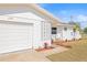 White garage with decorative block and landscaping at 11395 83Rd Ave, Seminole, FL 33772