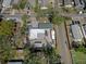 Aerial view of a residential property with multiple parking spaces, recreational vehicle, and an expansive yard at 1215 E Holland Ave, Tampa, FL 33612