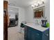 Elegant bathroom with navy vanity, quartz countertop, framed mirror, and ample storage space at 1215 E Holland Ave, Tampa, FL 33612