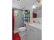 Bright bathroom featuring modern fixtures, a large mirror, and a tiled shower at 1215 E Holland Ave, Tampa, FL 33612