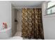 The bathroom includes a shower with patterned shower curtain and other bathroom accessories at 1215 E Holland Ave, Tampa, FL 33612