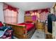 Bedroom featuring a wood frame bed, dresser, and side tables at 1215 E Holland Ave, Tampa, FL 33612