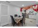 The dining room shows the kitchen, a table with four chairs, and luxury vinyl plank flooring at 1215 E Holland Ave, Tampa, FL 33612