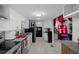 An open kitchen layout features stainless steel appliances, granite countertops, and seamlessly connects to other living areas at 1215 E Holland Ave, Tampa, FL 33612