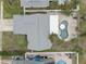 House with gray roof and kidney-shaped pool at 12391 70Th St, Largo, FL 33773