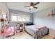 Bright bedroom with a queen bed, vanity, and tiled floor at 12391 70Th St, Largo, FL 33773