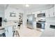 Modern kitchen with stainless steel appliances and white cabinets at 12391 70Th St, Largo, FL 33773