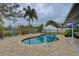 Relaxing kidney-shaped pool with patio and lounge chairs at 12391 70Th St, Largo, FL 33773