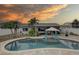 Inviting pool area with patio furniture and a large umbrella at 12391 70Th St, Largo, FL 33773