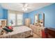 Bedroom with full-size bed, dresser and ceiling fan at 12433 Shadow Ridge Blvd, Hudson, FL 34669