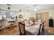 Dining room with a large table, six chairs and a view into the kitchen at 12433 Shadow Ridge Blvd, Hudson, FL 34669