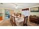 Bright dining room with a wooden table, six chairs and an organ at 12433 Shadow Ridge Blvd, Hudson, FL 34669