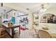 Kitchen with white cabinets, a breakfast bar and a view into the dining area at 12433 Shadow Ridge Blvd, Hudson, FL 34669