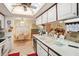 Bright kitchen with white cabinets, double sink, and adjacent dining area at 12433 Shadow Ridge Blvd, Hudson, FL 34669