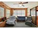 Relaxing sunroom with comfy seating and ceiling fan at 12433 Shadow Ridge Blvd, Hudson, FL 34669