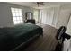 Bedroom with wood floors, large windows, and bi-fold closet doors at 13909 Fletchers Mill Dr, Tampa, FL 33613