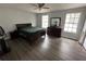 Large bedroom with double windows, laminate floor, and a dark wood bed at 13909 Fletchers Mill Dr, Tampa, FL 33613