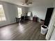 Bright bedroom with large windows, dark wood dresser, and laminate flooring at 13909 Fletchers Mill Dr, Tampa, FL 33613