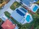 Aerial view of house with solar panels, pool, and lush landscaping at 14311 83Rd Pl, Seminole, FL 33776