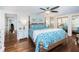 Main bedroom with wood flooring and a king-size bed at 14311 83Rd Pl, Seminole, FL 33776