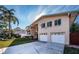 Two-story house with two-car garage and palm tree at 14311 83Rd Pl, Seminole, FL 33776