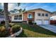 Two-story house with a brick facade, attached garage, and manicured lawn at 14311 83Rd Pl, Seminole, FL 33776