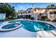 Large pool with spa, screened patio, and home in background at 14311 83Rd Pl, Seminole, FL 33776