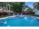 Relaxing kidney-shaped pool with a spa and lush landscaping at 14311 83Rd Pl, Seminole, FL 33776