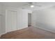 Well-lit bedroom with double door closet and carpet flooring at 15716 Country Lake Dr, Tampa, FL 33624