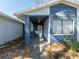 Covered front porch with a white door and blue accents at 15716 Country Lake Dr, Tampa, FL 33624